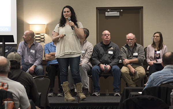 Picture of woman addressing a large group.